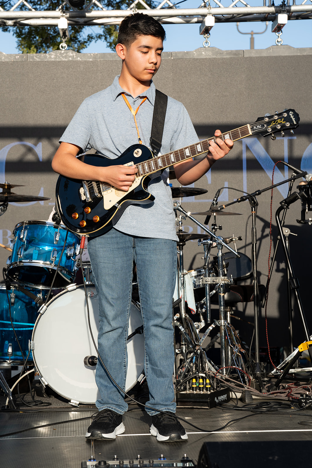 Young electric guitarist performing on stage